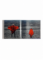 Two figures in vivid red capes occupy a rugged terrain—one stands with arms wide open, the other strides away—framed within the pages of ISSEY MIYAKE (Limited Collectors Edition) by ISSEY MIYAKE BOOKS. This compelling composition captures the brand’s commitment to bold visual storytelling and artistic innovation.
