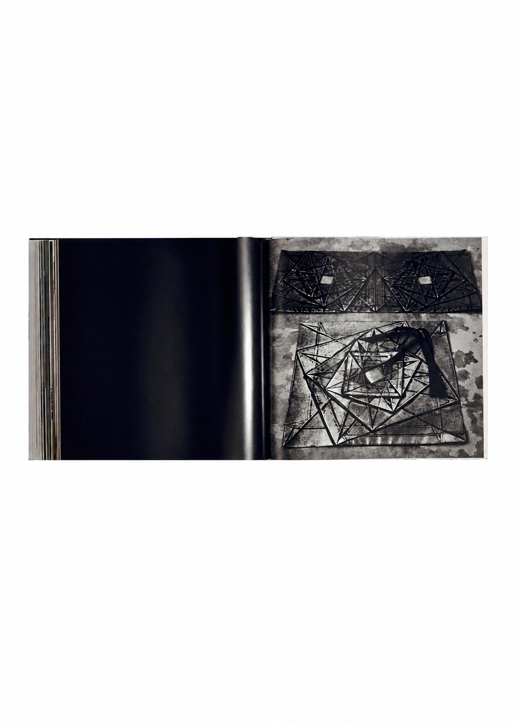 An open book from ISSEY MIYAKE BOOKS, titled ISSEY MIYAKE (Limited Collectors Edition), displays a mostly blank left page and a right page featuring abstract geometric black line art on a textured gray background, evoking the refined design philosophy characteristic of high-end collector’s editions. view 8 of 17