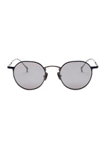 ISSEY MIYAKE EYES PANT Ⅲ round titanium sunglasses with dark metal frames and light grey tinted lenses.