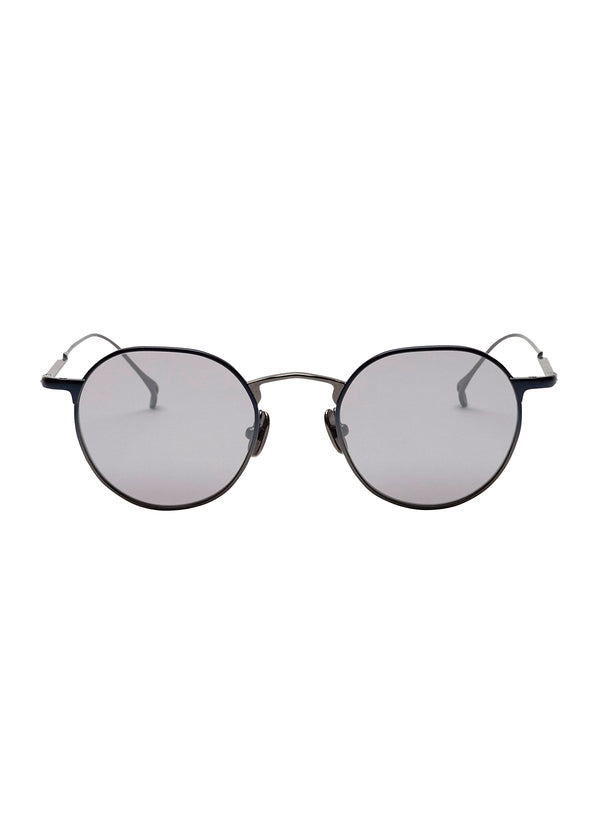 Zoomed view ISSEY MIYAKE EYES PANT Ⅲ round titanium sunglasses with dark metal frames and light grey tinted lenses.